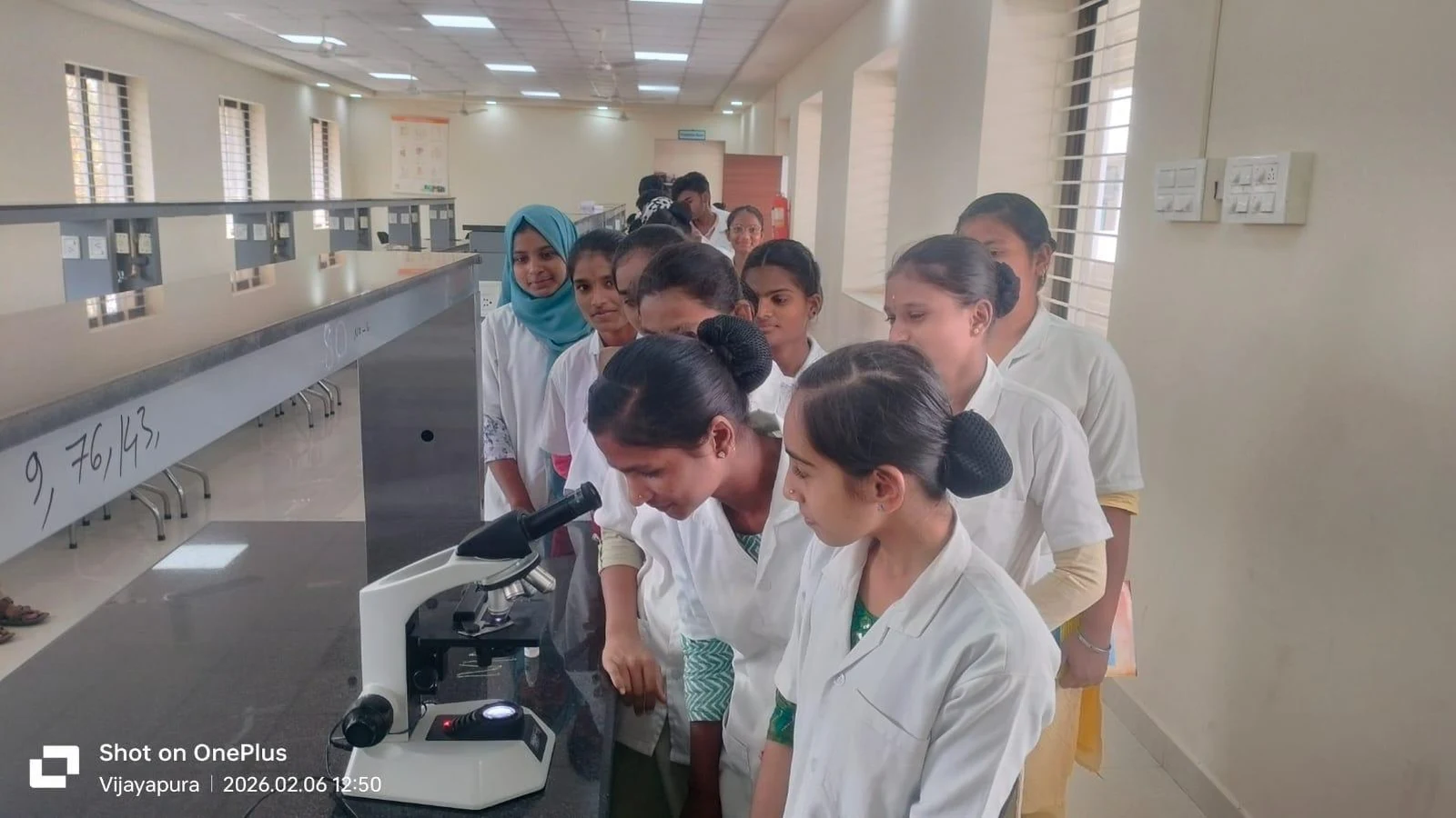 BLDEA Nursing Jamkhandi students observing microscopic blood specimens in Physiology Department laboratory at Shri BM Patil Medical College Vijayapura with Dr. Sandeep Shah and Dr. Vijaykumar K.