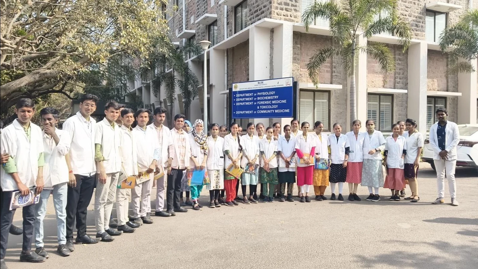 First Semester BSc Nursing students and faculty from BLDEA College of Nursing Jamkhandi group photo in front of Department of Physiology Biochemistry Forensic Medicine sign at BLDE University Vijayapura