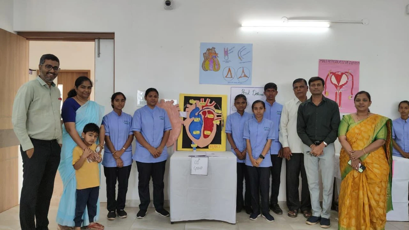 Group I students and distinguished guests with Circulatory System heart model at Anatomy Physiology Model Exhibition 2026 – BLDEA College of Nursing Jamkhandi