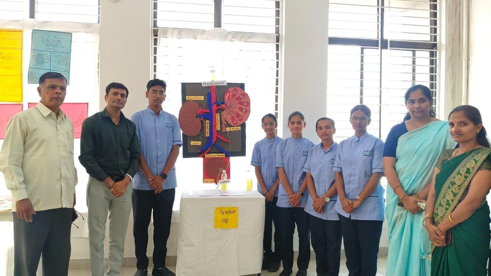 Students and faculty with Renal System 3D kidney model at Anatomy Physiology Model Exhibition 2026 – BLDEA College of Nursing Jamkhandi