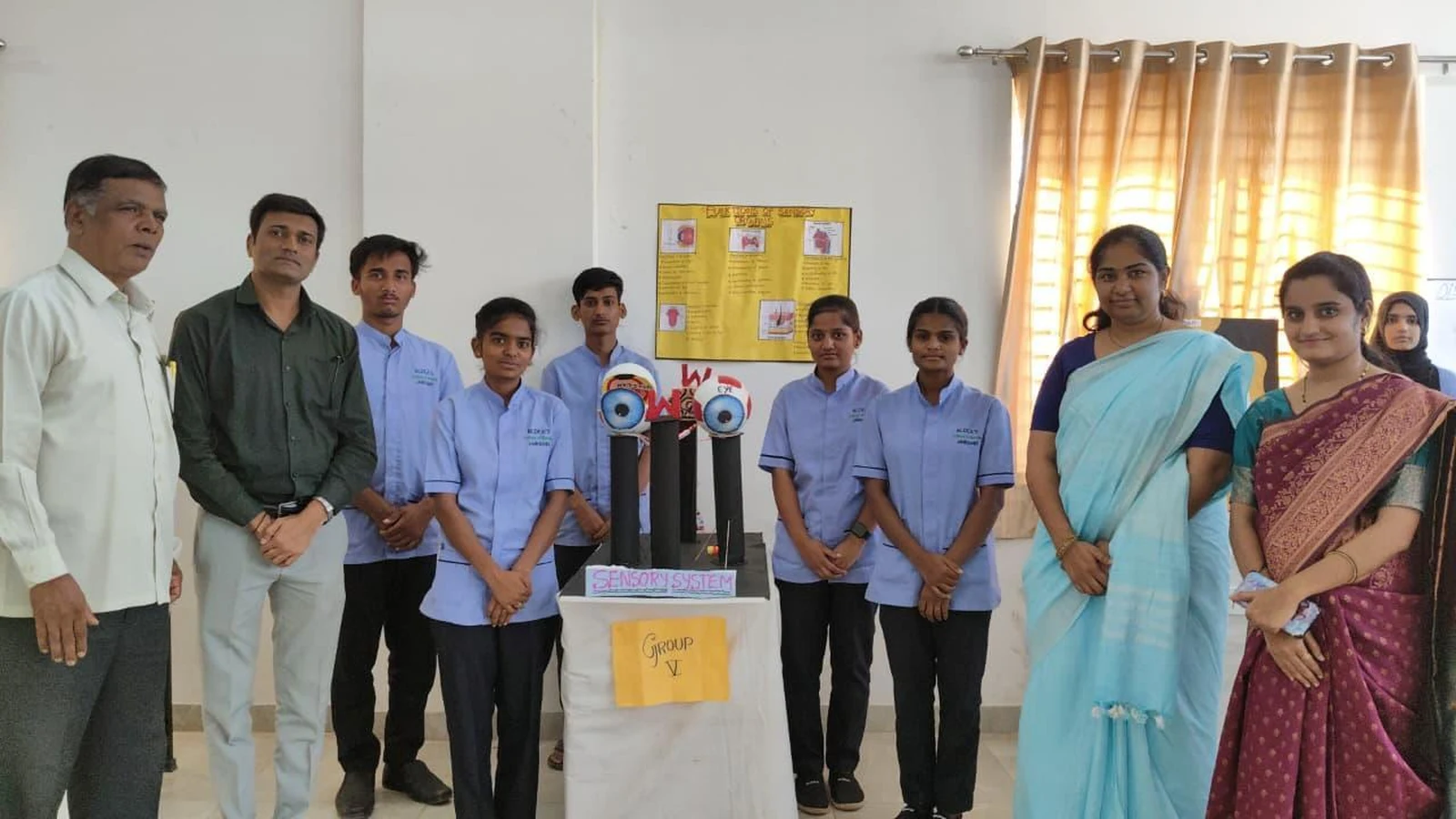 Group VI students with Skin Integumentary System model at Anatomy Physiology Model Exhibition 2026 – BLDEA College of Nursing Jamkhandi