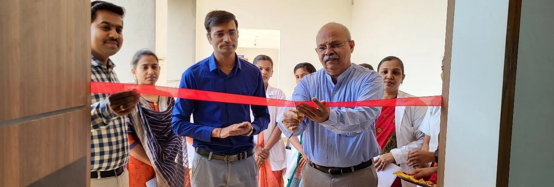 Dr Veeranna S Jatti Ayurvedic Physician Shri Vinayaka Ayurvedic Hospital Jamkhandi cutting ribbon to inaugurate Anatomy and Physiology Model Exhibition organized by first semester BSc Nursing students at BLDEAS College of Nursing Jamkhandi March 21 2025