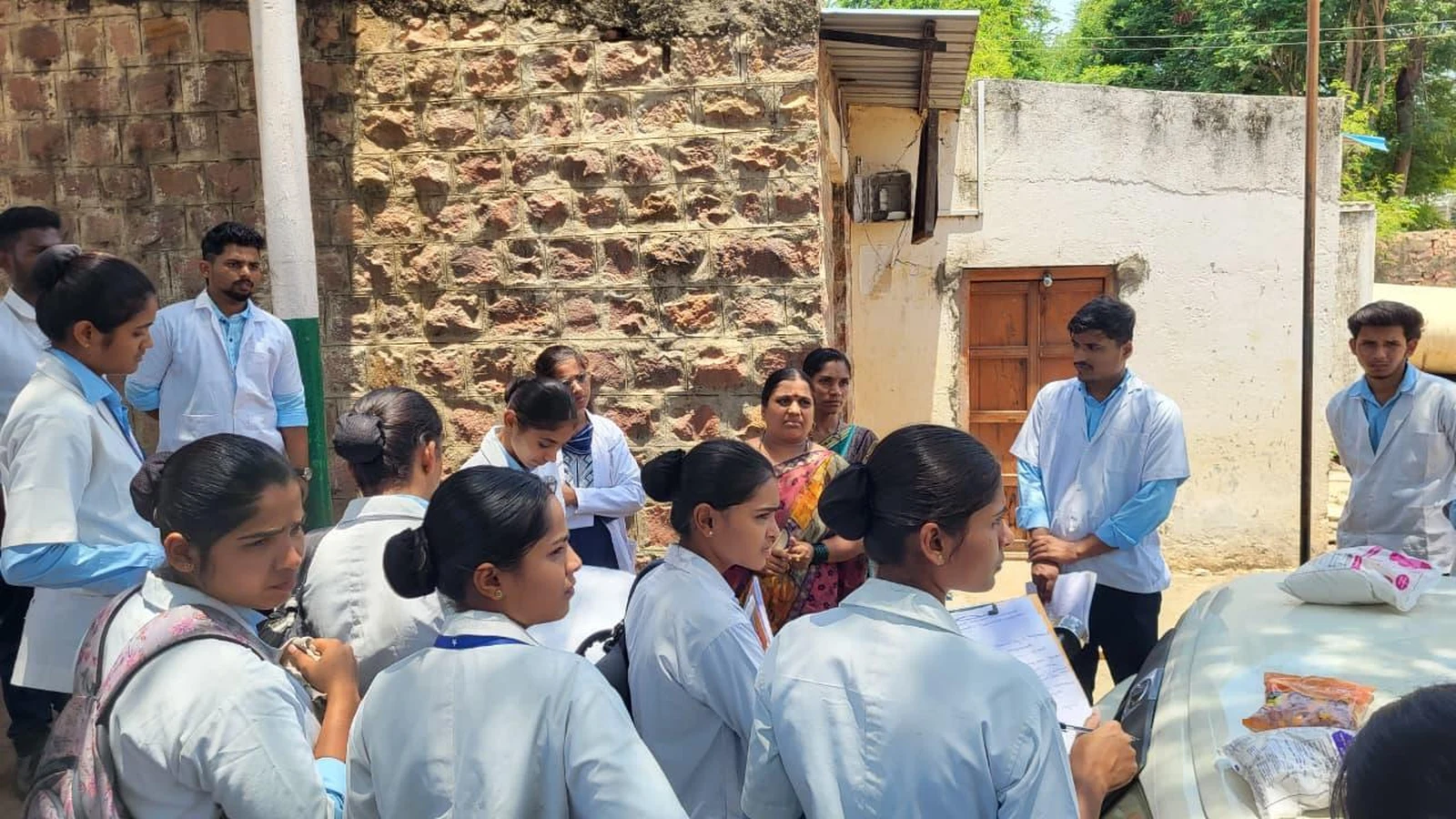 BLDEA College of Nursing Jamkhandi BSc Nursing students attending outdoor orientation session by Anganwadi worker Mrs Neelamma Gudodagi at Anganwadi Centre Kakanawadi during Community Health Nursing visit June 2026