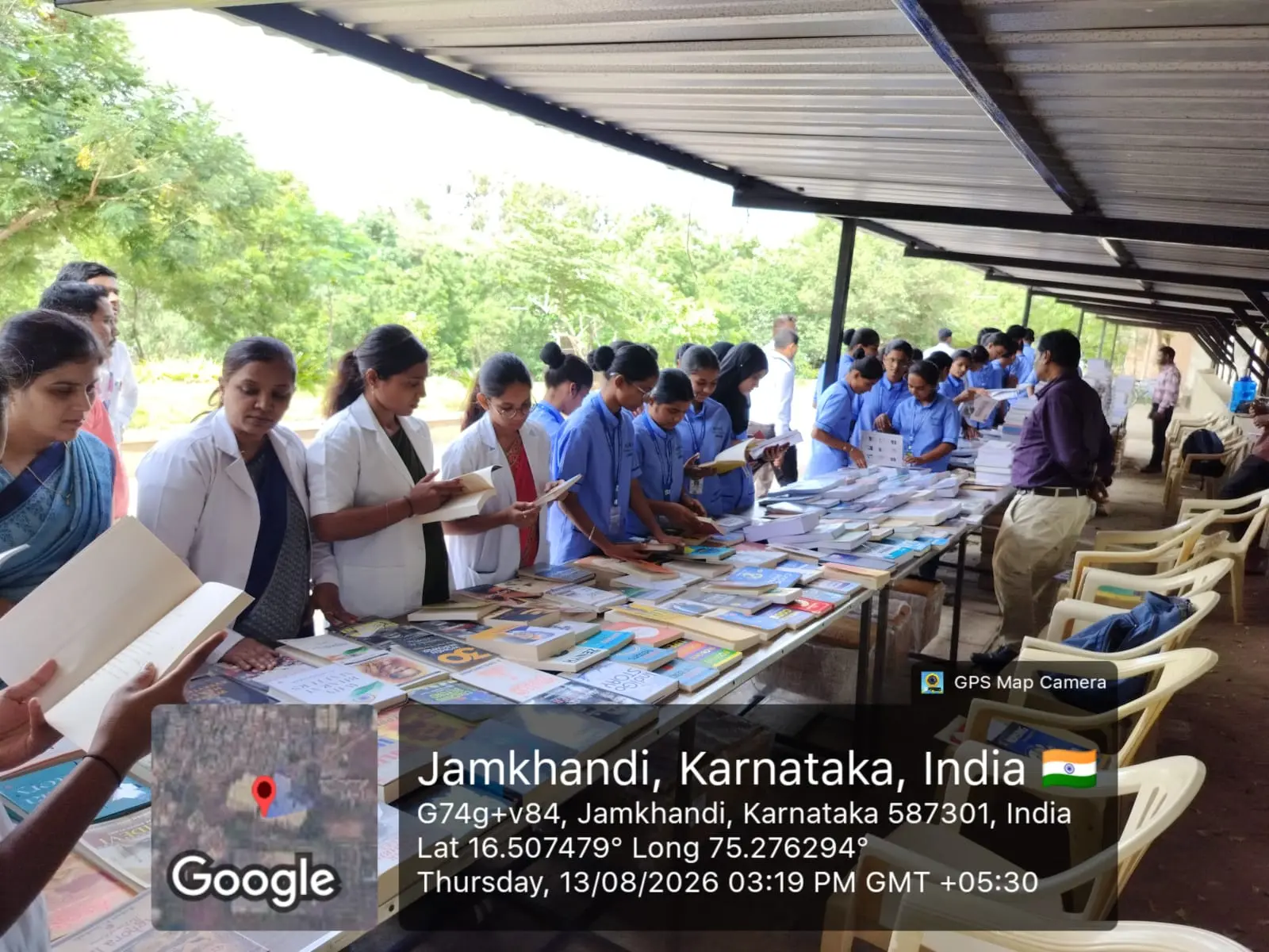 Faculty members reviewing new reference books at Book Exhibition BLDE Central Library Jamkhandi National Librarians Day
