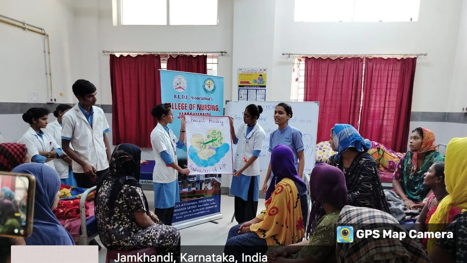 BSc Nursing students of BLDEAS College of Nursing Jamkhandi demonstrating breastfeeding positions and benefits using illustrated heart-shaped educational chart to antenatal and postnatal mothers at Taluka Hospital Jamkhandi during World Breastfeeding Week August 6 2024