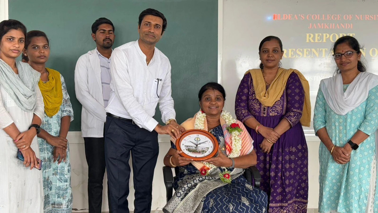 Prof Dr Sheela Kaddimani Chief Guest Department of Community Health Nursing Gopala Gowda Shathaveri Memorial College of Nursing Mysore being felicitated with memento and bouquet by students and faculty at Community Health Nursing Report Presentation BLDEAS College of Nursing Jamkhandi July 19 2025