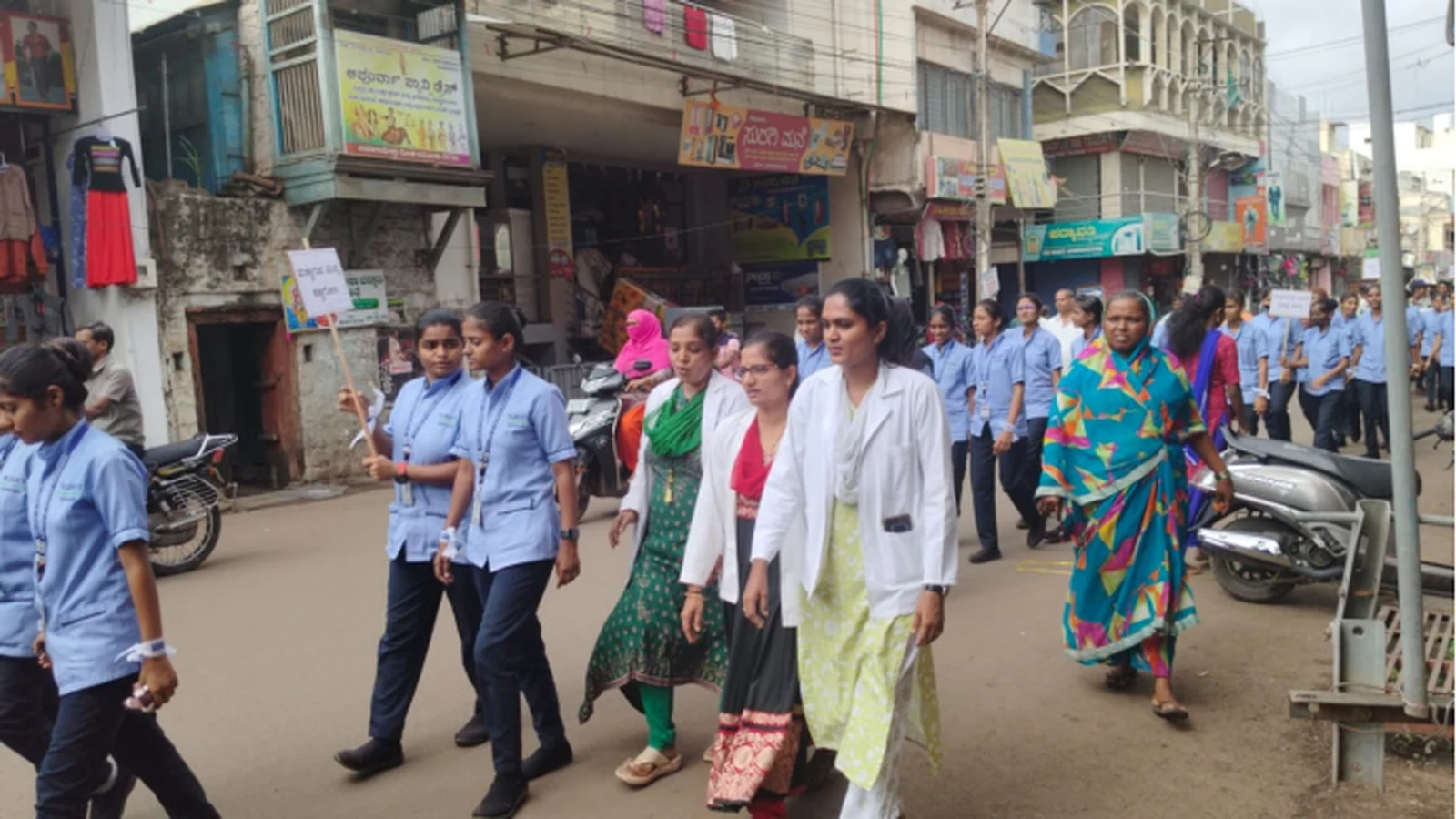 BLDEAS College of Nursing Jamkhandi students faculty and staff marching through Jamkhandi town streets during Eye Donation Awareness Rally National Eye Donation Week September 4 2024 in uniform with placards and colorful headbands spreading awareness about eye donation