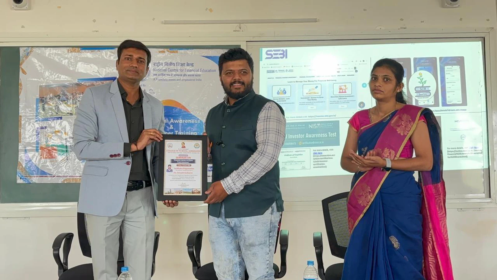 Principal presenting memento and certificate to Mr. Srinath Kulkarni SEBI Security Market Trainer at Financial Literacy Seminar – BLDEA College of Nursing Jamkhandi