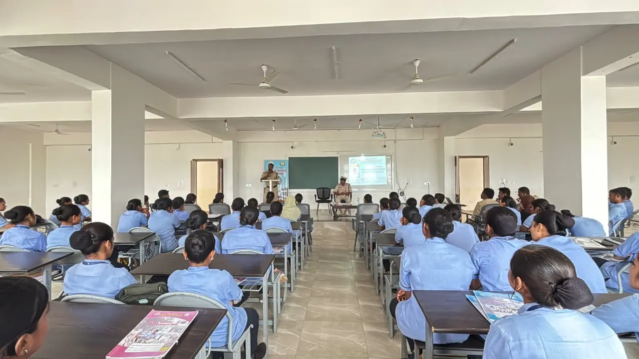 Fireman demonstrating safe handling of LPG cylinder fire using wet blanket technique at BLDEA College of Nursing Jamkhandi