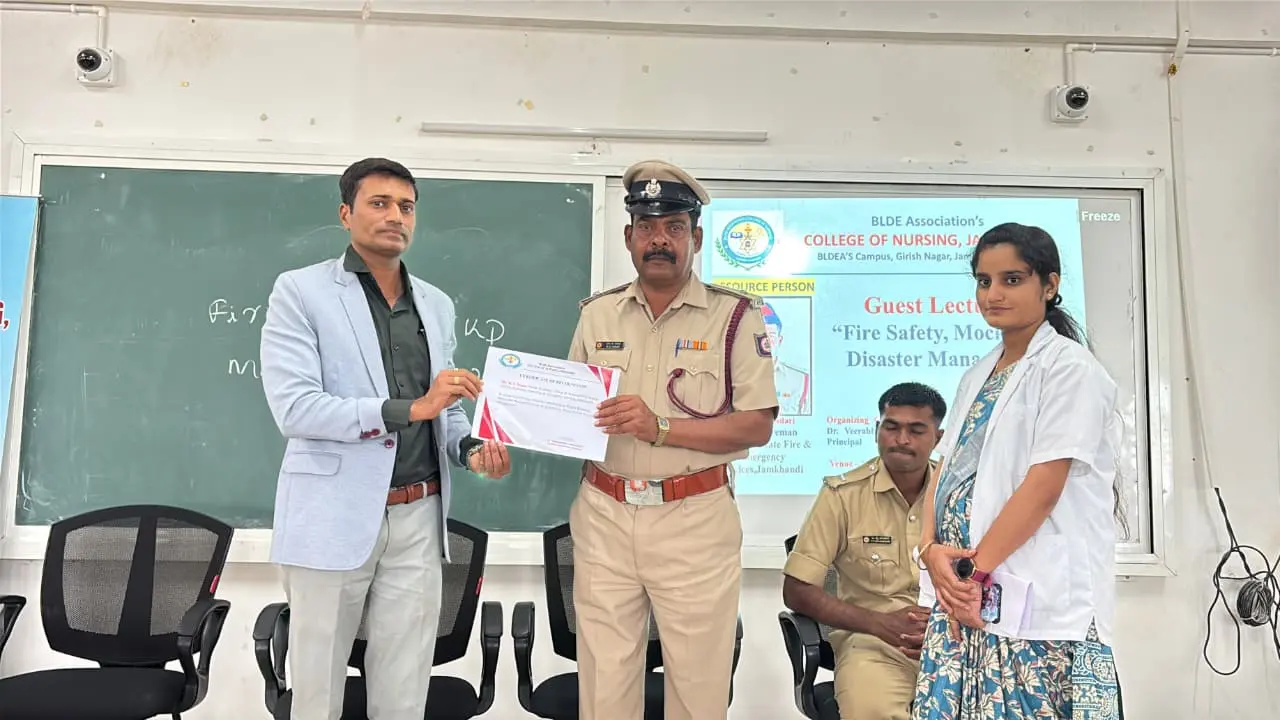 Karnataka Fire and Emergency Services personnel demonstrating fire extinguisher use to nursing students Jamkhandi campus