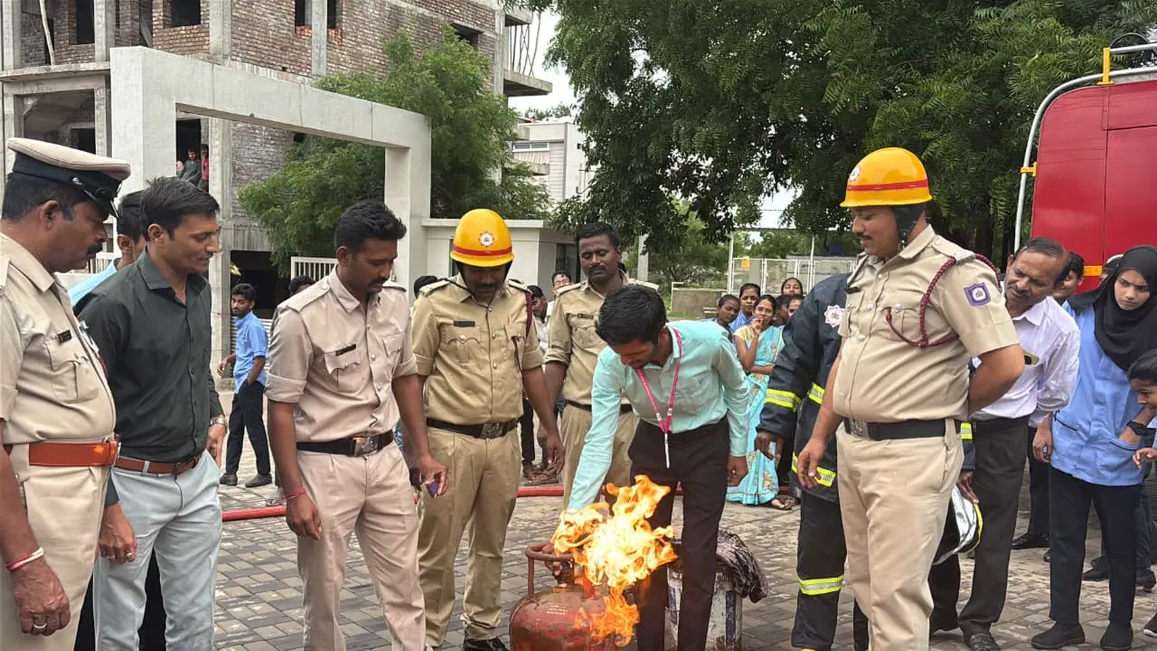 B Sc Nursing students practising fire extinguisher operation under supervision of fire officers Jamkhandi mock drill 2026