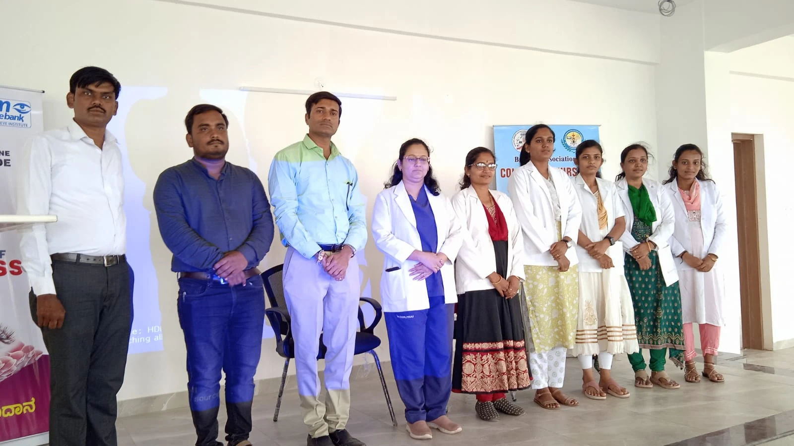 Group photograph of MM Joshi Eye Institute Jamkhandi medical team and BLDEAS College of Nursing Jamkhandi faculty and staff standing together after Free Eye Screening Camp at Seminar Hall BLDEAS College of Nursing Jamkhandi September 4 2024 National Eye Donation Week with SGM eyebank Netradana Pledge Your Eyes banner on left and BLDEAS College of Nursing Jamkhandi banner