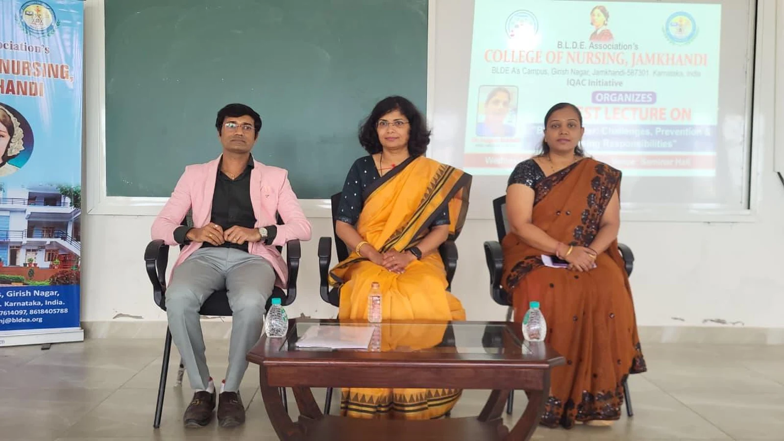 Dignitaries seated at dais during guest lecture on Blood Cancer at BLDEA College of Nursing Jamkhandi including Dr Sangam Hebballi Consultant Haematologist Worcestershire Acute Hospitals NHS Trust UK and faculty members October 15 2025