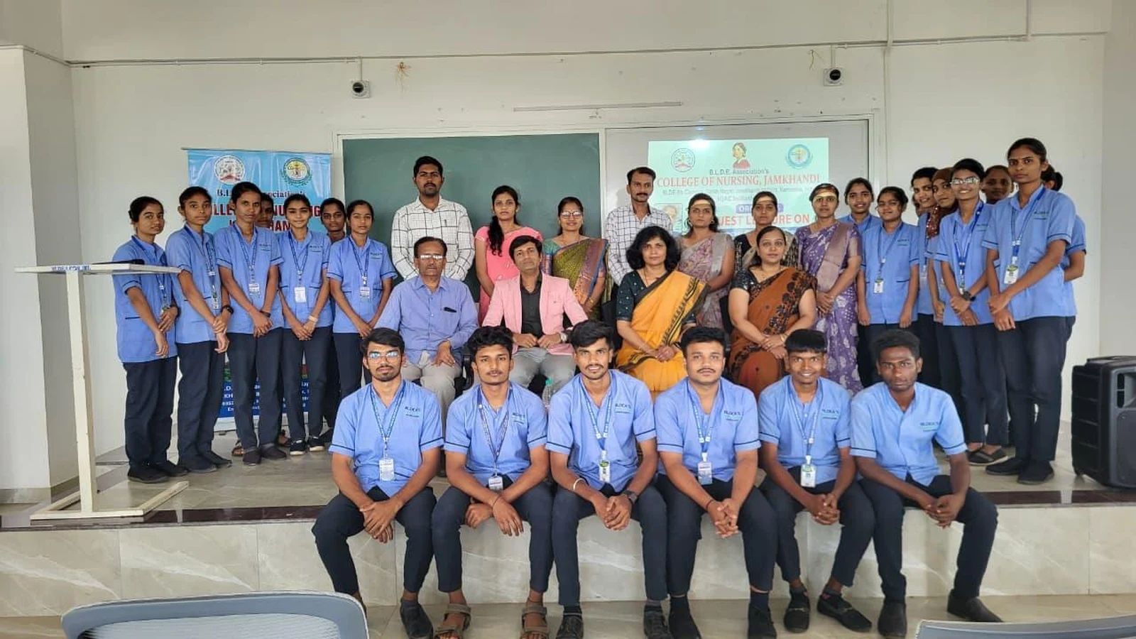 Group photograph of B.Sc. Nursing students in blue uniforms with faculty members at guest lecture on Blood Cancer Challenges Prevention and Nursing Responsibilities at BLDEA College of Nursing Jamkhandi October 15 2025