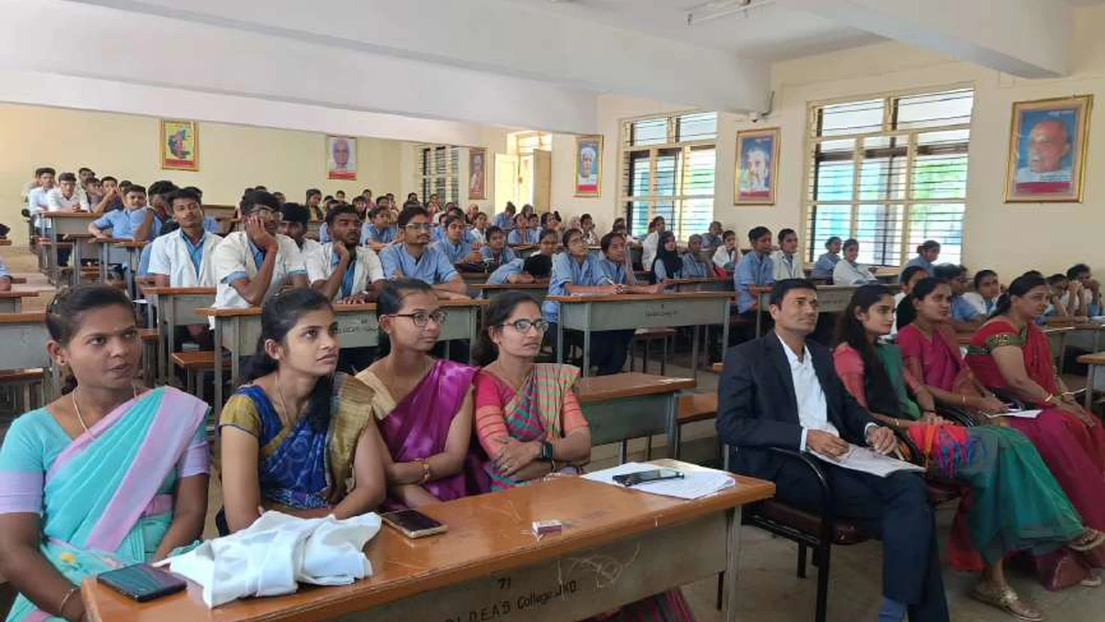 BSc Nursing students and faculty members of BLDEAS College of Nursing Jamkhandi seated in classroom attentively attending guest lecture on Bridging The Gap Cancer Awareness Early Detection and Patient Support by Dr Krishna Bannad Medical Officer Taluka Hospital Jamkhandi at Lecture Hall No 1 BLDEAS College of Nursing Jamkhandi November 9 2024
