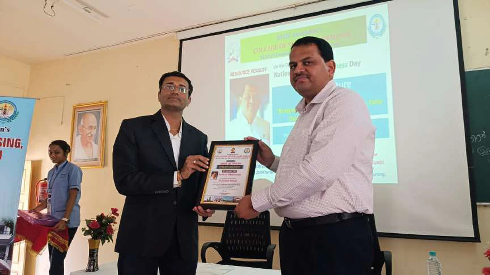 Dr Veerabhadrappa G Mendagudli Principal BLDEAS College of Nursing Jamkhandi presenting certificate of appreciation and memento to Dr Krishna Bannad Medical Officer Taluka Hospital Jamkhandi at conclusion of guest lecture on Bridging The Gap Cancer Awareness Early Detection and Patient Support on National Cancer Awareness Day at BLDEAS College of Nursing Jamkhandi November 9 2024