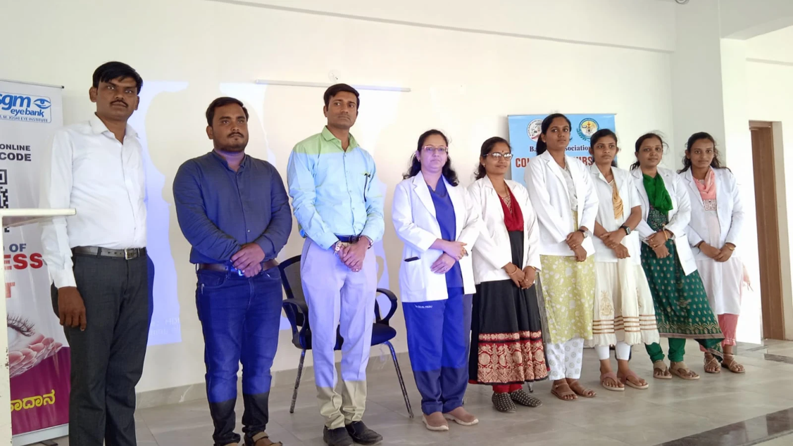 Group photograph of Dr Deepa Udagatti Consultant Ophthalmologist MM Joshi Eye Institute Mr Somesh Nikkam PG Nursing Tutor and BLDEAS College of Nursing Jamkhandi faculty and students after Guest Lecture on Eye Care and Eye Donation Awareness on National Eye Donation Week September 4 2024 Seminar Hall Jamkhandi with MM Joshi Eye Institute Netradana banner