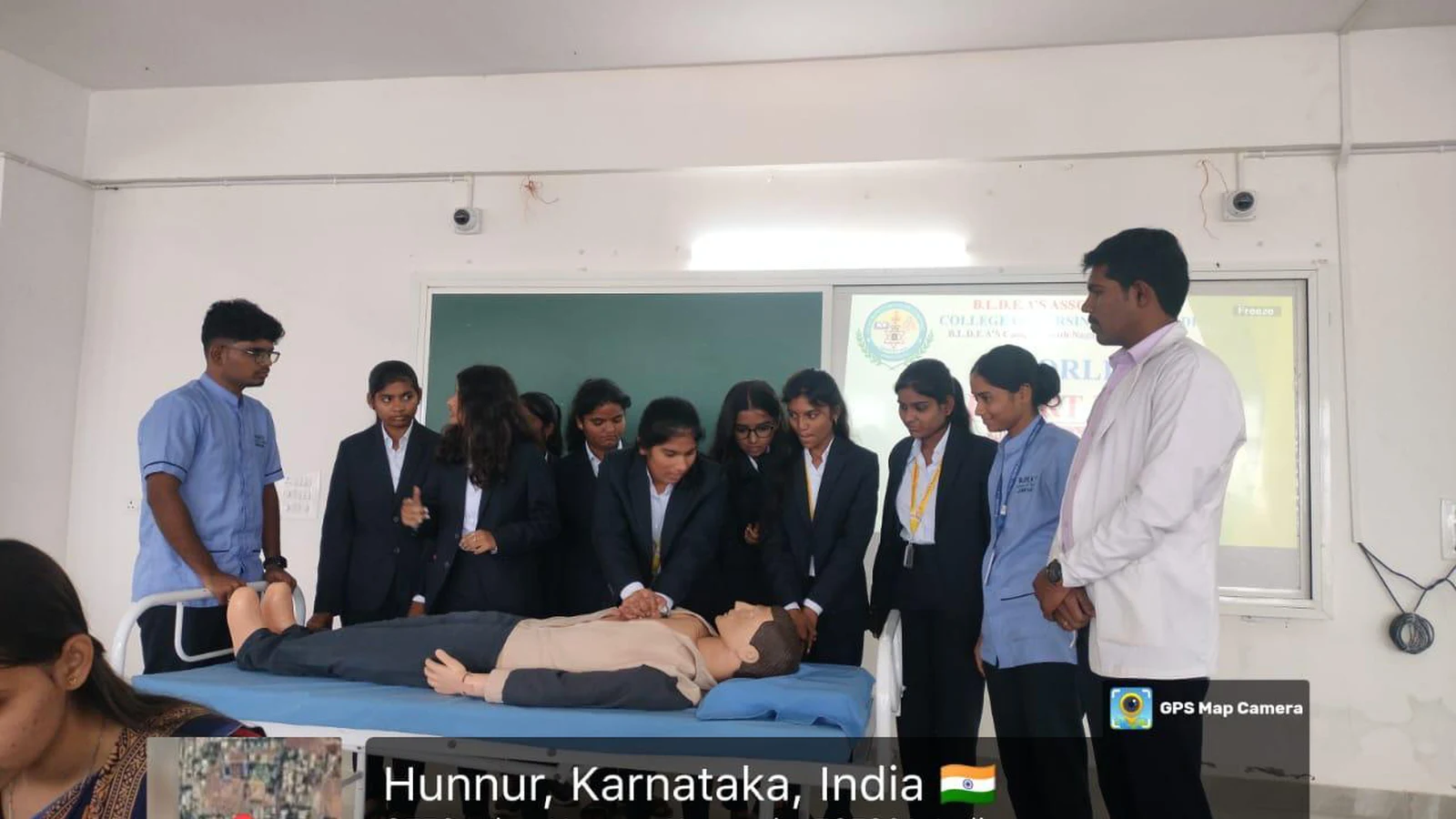 Staff and students from BLDE BBA Jamkhandi observing CPR demonstration on mannequin during hands-on CPR training organized by BLDEAS College of Nursing for World Heart Day 2025 at Seminar Hall Jamkhandi