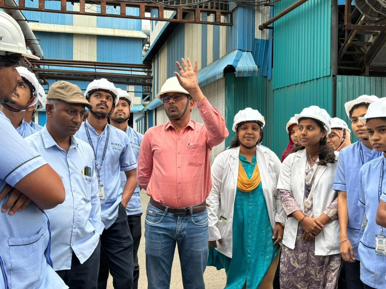 Factory official briefing nursing students at Nirani Sugars Factory – Industrial Visit 2026, BLDEA College of Nursing Jamkhandi