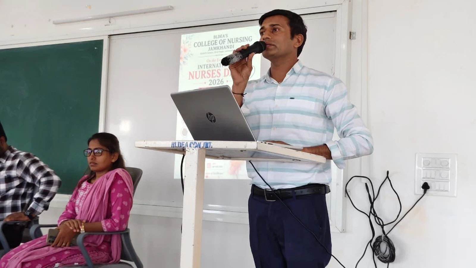 Judge Mr. Suresh Biradar addressing participants at Intercollegiate Solo Singing Competition 2026 – BLDEA College of Nursing Jamkhandi
