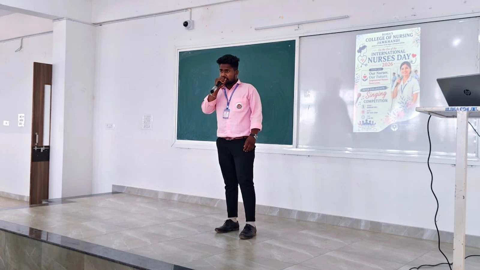 Participant performing patriotic solo song on stage at Intercollegiate Solo Singing Competition 2026 – BLDEA College of Nursing Jamkhandi