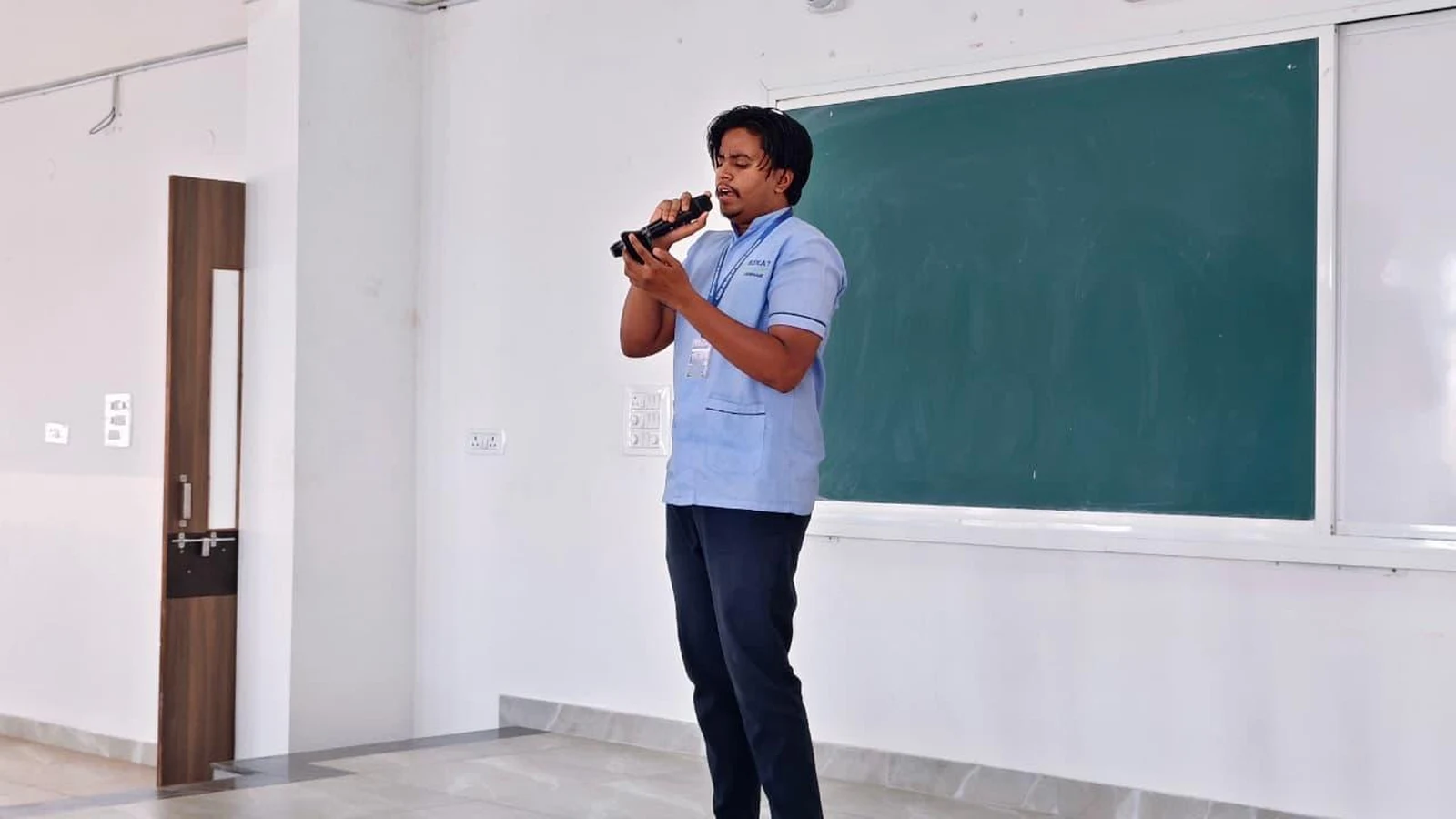 Student singing motivational song at Intercollegiate Solo Singing Competition 2026 – BLDEA College of Nursing Jamkhandi