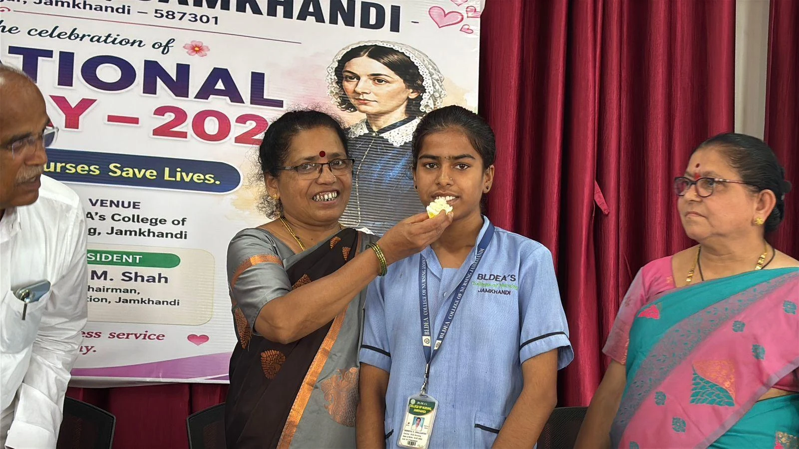 Cake being fed to a nursing student – International Nurses Day 2026, BLDEA College of Nursing Jamkhandi