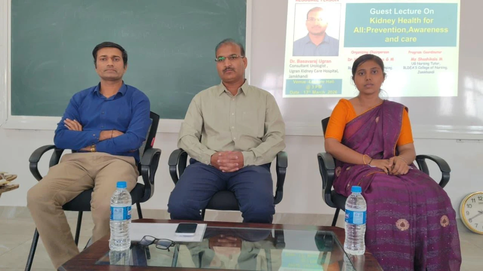 Dignitaries and Dr. Basavaraj Ugran seated at Guest Lecture on Kidney Health for All event slide visible – BLDEA College of Nursing Jamkhandi
