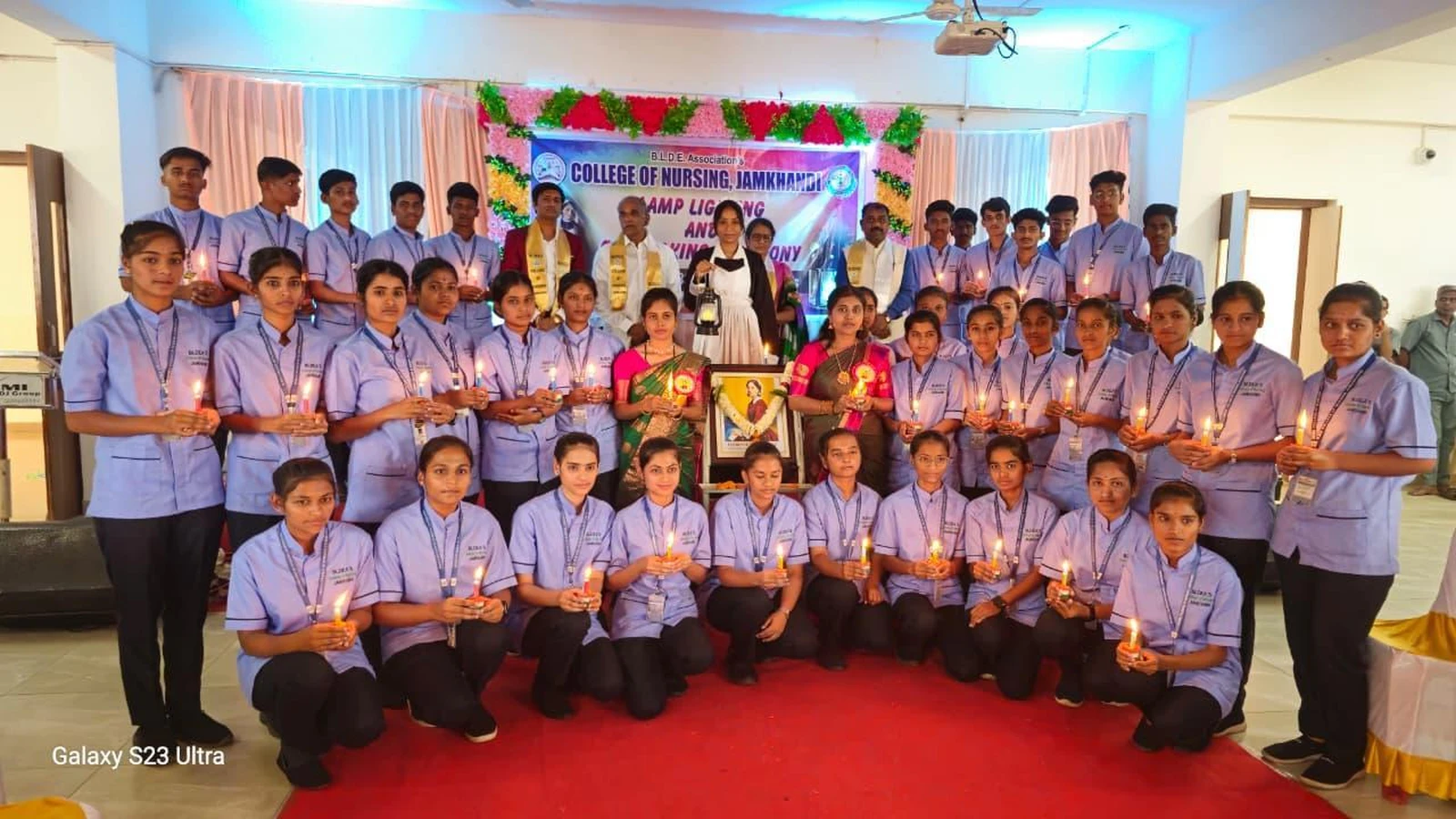 First Year BSc Nursing students holding lighted candles after Oath Taking Ceremony at BLDEA College of Nursing Jamkhandi 2026