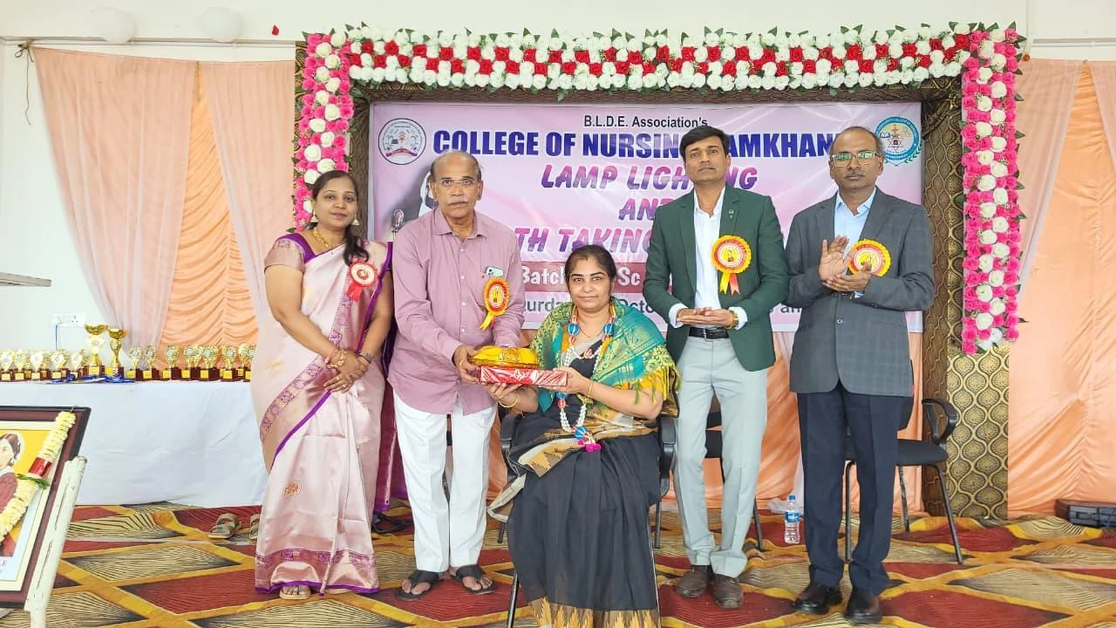Dignitaries presenting felicitation memento and certificate to Chief Guest Dr Sphurti Tungal Consultant Gynaecologist Tungal Nursing Home Jamkhandi at Lamp Lighting and Oath Taking Ceremony 2025 BLDEA College of Nursing Jamkhandi October 25 2025