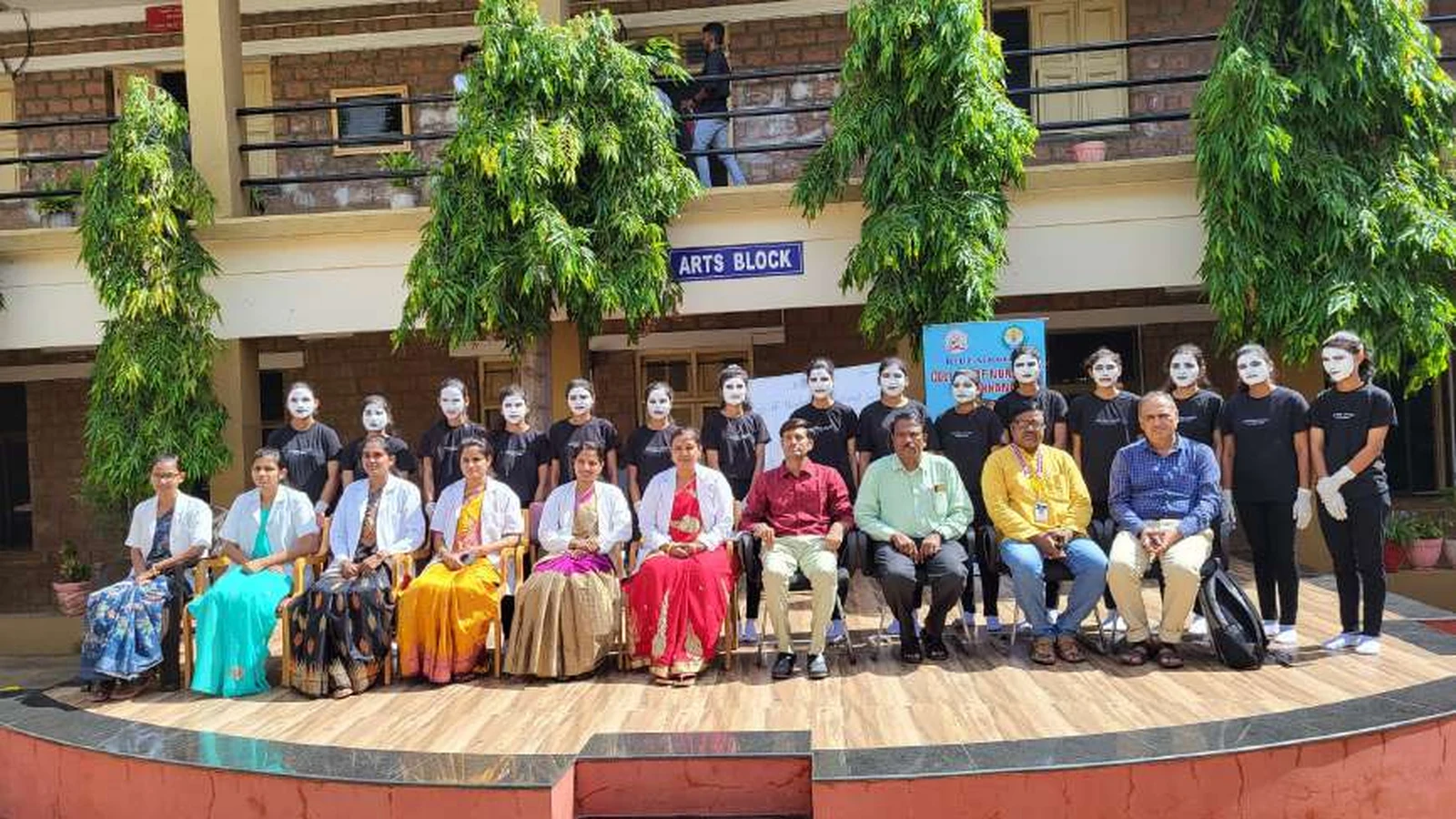 Formal group photo of second semester BSc Nursing students and dignitaries including Prof BI Karalatti Dr Veerabhadrappa G Mendagudli Dr VS Kulkarni and coordinators Ms Keerti Halemani and Ms Jyoti Mareguddi on stage after World Population Day 2024 mime show at BLDEAS College of Nursing Jamkhandi July 11 2024