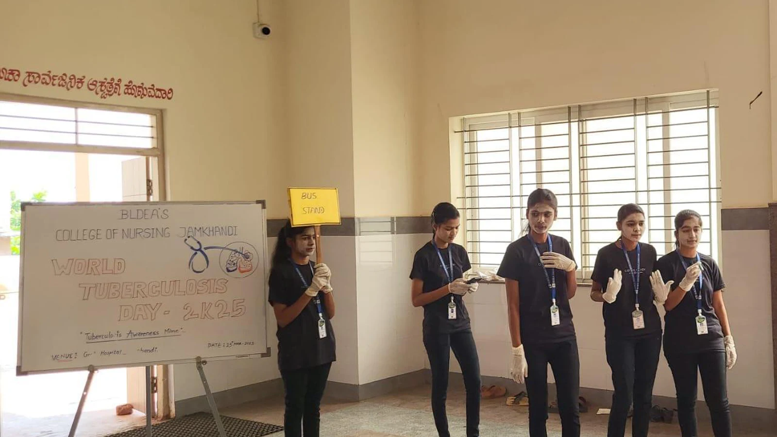 BLDEAS College of Nursing Jamkhandi World Tuberculosis Day 2025 awareness whiteboard with third semester BSc Nursing students in black outfits standing at Taluka Hospital Jamkhandi March 25 2025