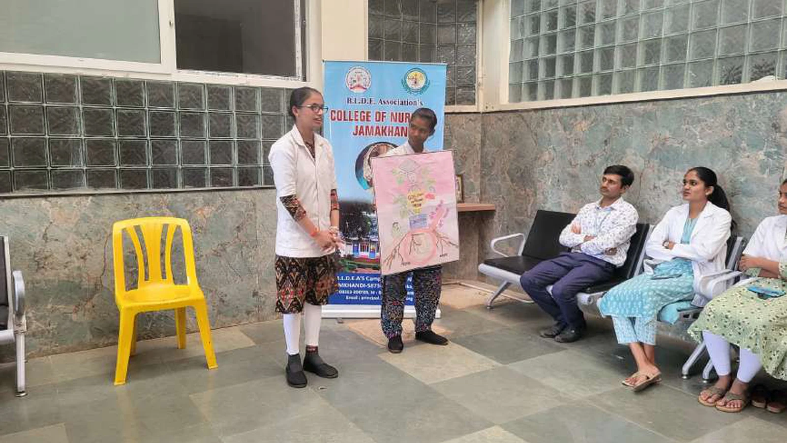 Female first semester BSc Nursing student holding colorful girl child awareness poster at National Girl Child Day awareness program organized by BLDEAS College of Nursing Jamkhandi at Tungal Hospital January 24 2024