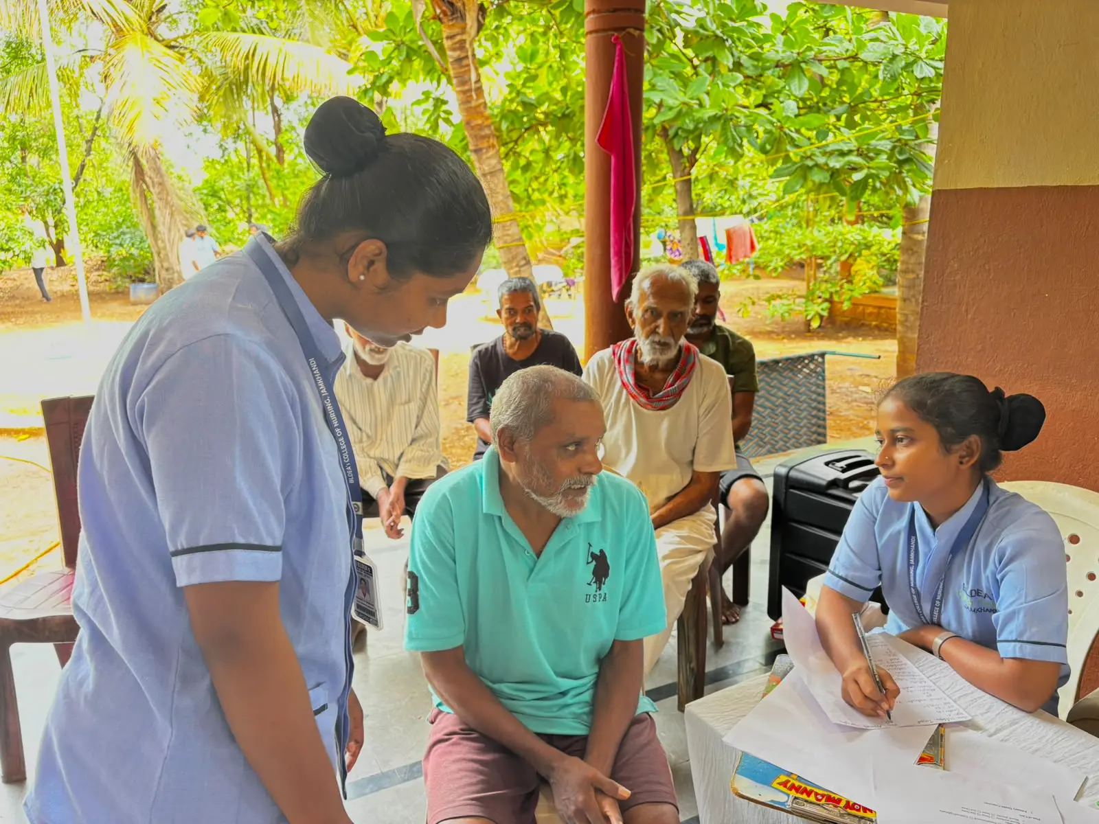 Nursing student providing wound dressing to elderly resident during health camp at Jain Vrudhrashram old age home Jamkhandi
