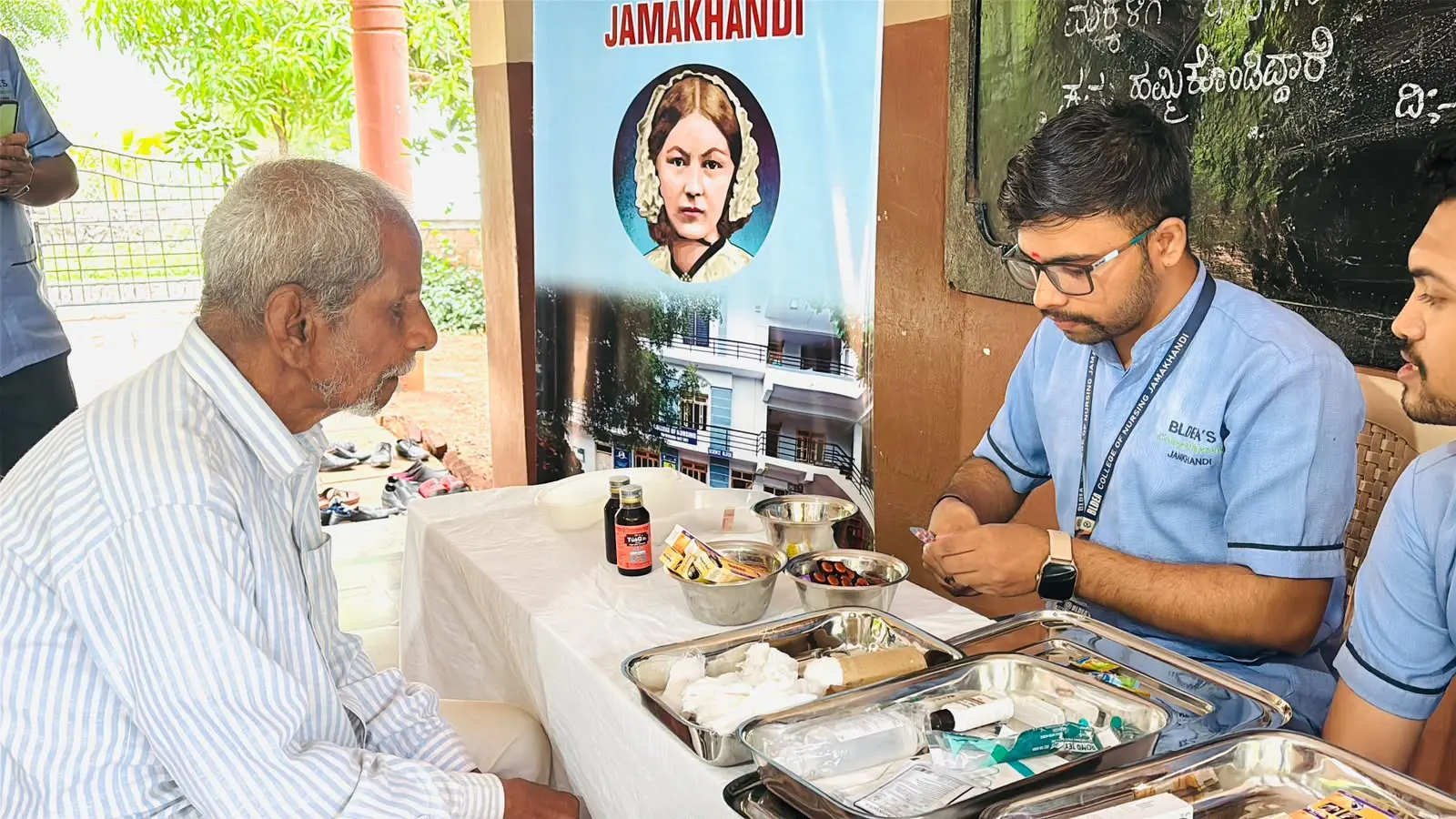 Nursing students distributing multivitamin and calcium tablets to elderly residents after health screening Jain Vrudhrashram Jamkhandi