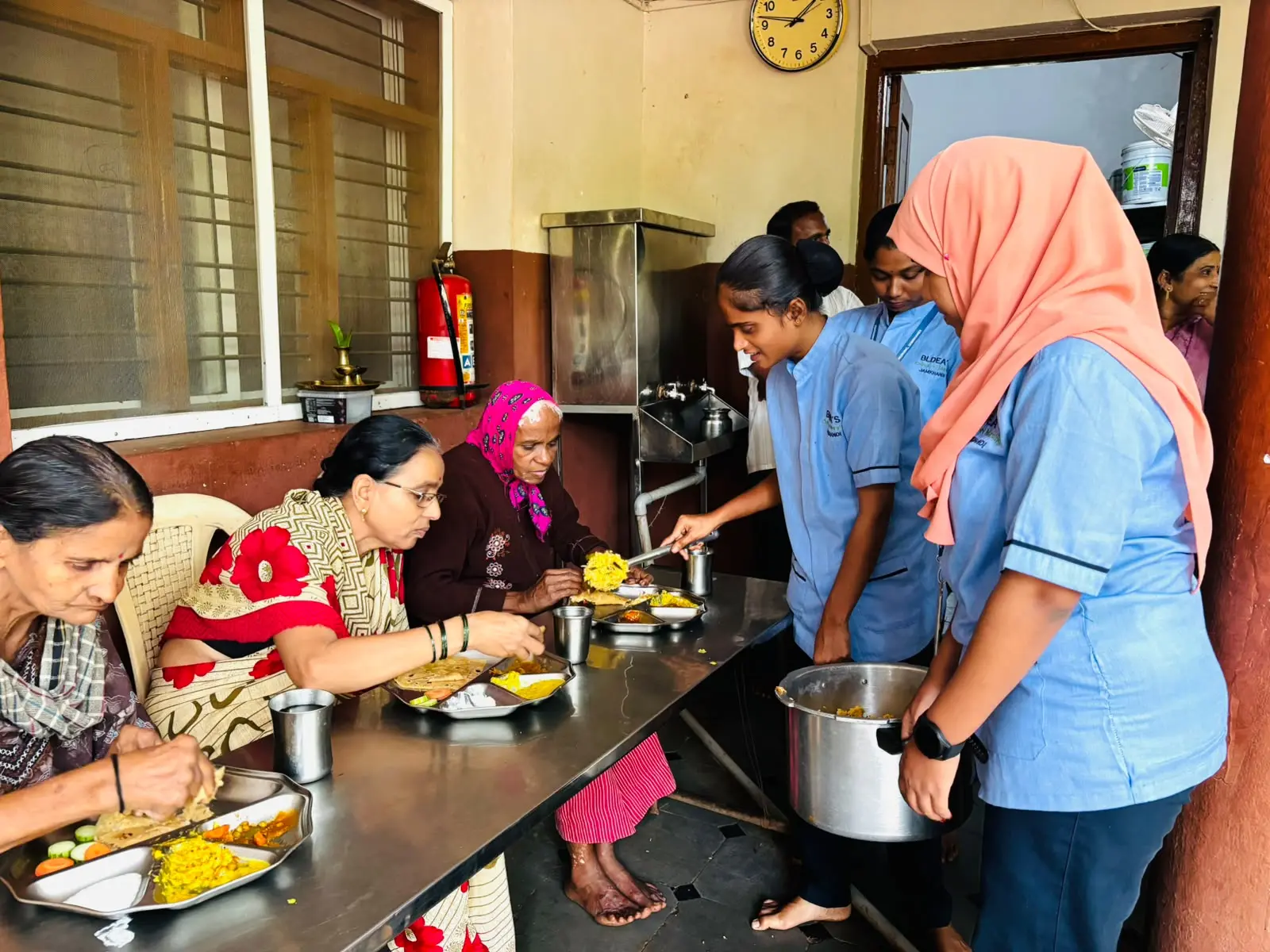 Elderly residents dancing joyfully with BLDEA College of Nursing students during cultural programme at old age home Jamkhandi