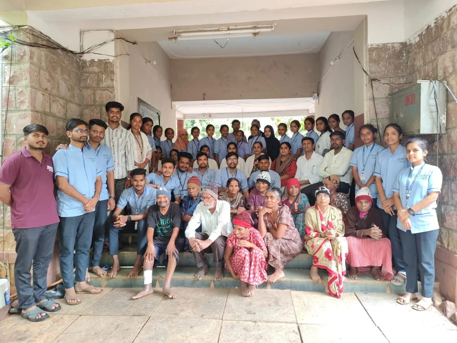 Group photograph of Seventh Semester B Sc Nursing students faculty and elderly residents at Jain Vrudhrashram Jamkhandi July 2026