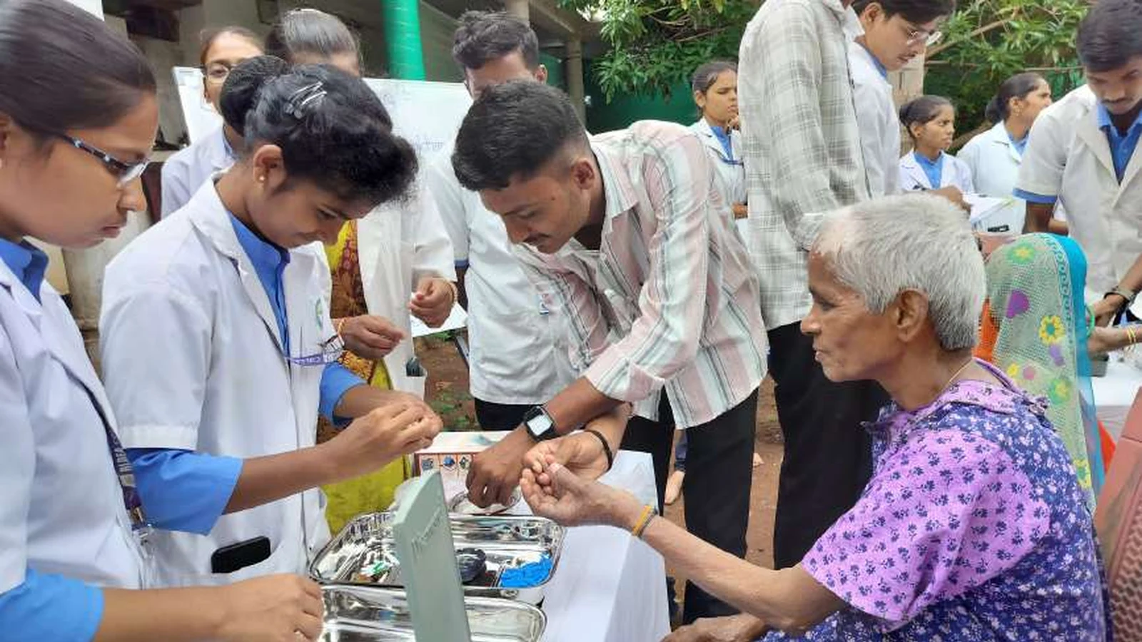 Third year BSc Nursing students of BLDEAS College of Nursing Jamkhandi distributing vitamins calcium tablets and medications to elderly woman resident at Jain Vrudhrashram Jamkhandi during geriatric health assessment visit July 18 2024
