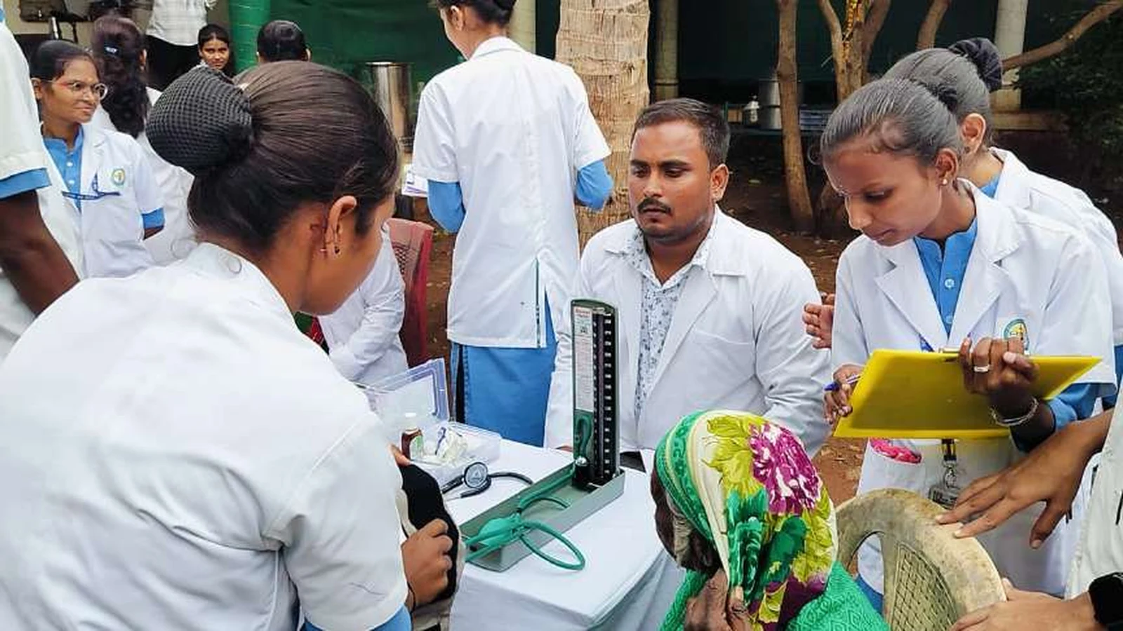 Third year BSc Nursing students of BLDEAS College of Nursing Jamkhandi checking blood pressure of elderly female resident with sphygmomanometer and recording findings at Jain Vrudhrashram Jamkhandi July 18 2024