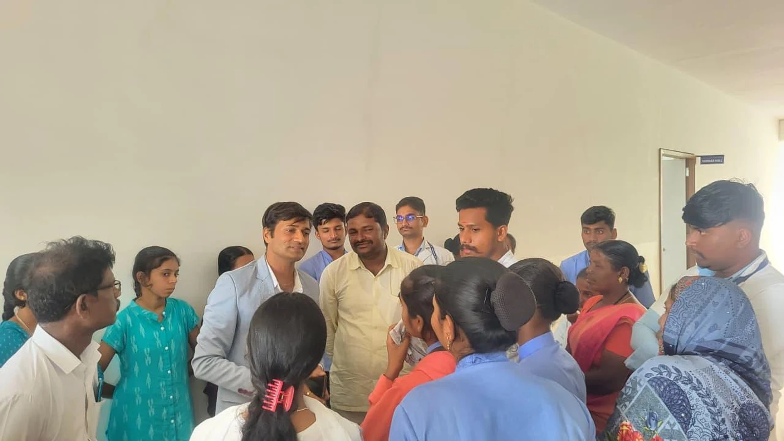 Faculty and students interacting informally with parents in group discussion during Parent-Teacher Meeting at BLDEA College of Nursing Jamkhandi June 2026