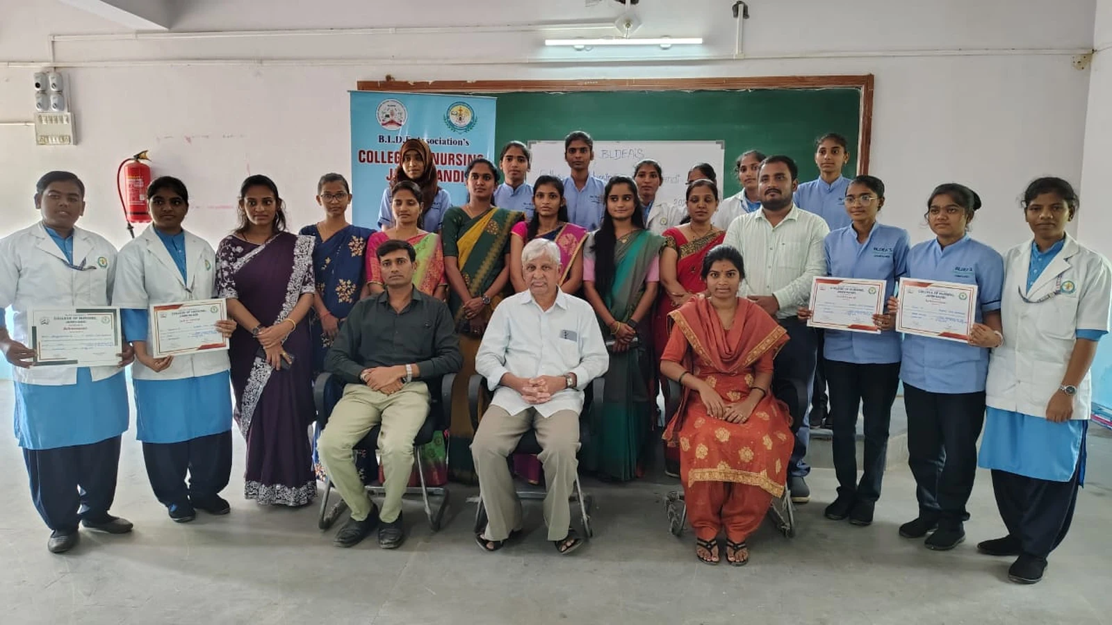 Full group photograph of judges faculty and BSc Nursing students holding prize certificates after World Breastfeeding Week Poster Competition BLDEAS College of Nursing Jamkhandi August 7 2024