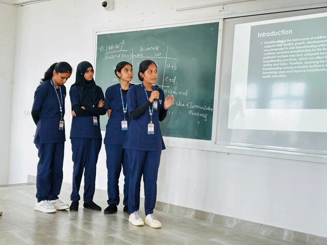 Nursing student group presenting research topic slides to evaluation panel Jamkhandi College of Nursing August 2026