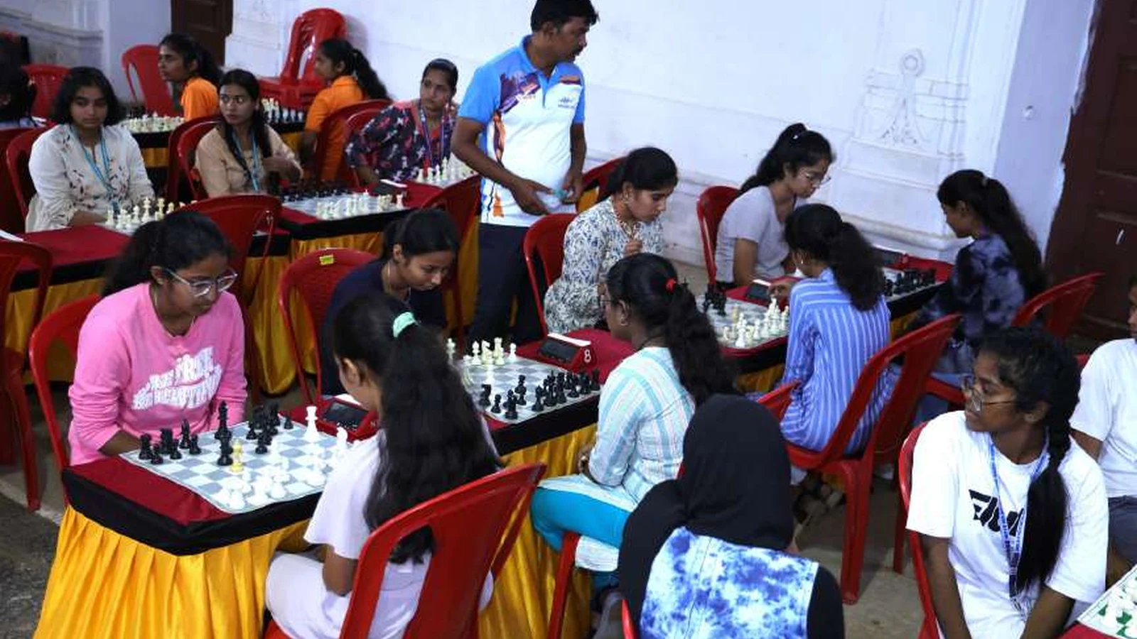Female chess players from health sciences colleges affiliated with RGUHS Kalaburagi Zone competing at chess boards during RGUHS Kalaburagi Zone Chess Women Tournament 2024 hosted by BLDEAS College of Nursing Jamkhandi at Darbar Hall BLDEA Campus August 23 24 2024