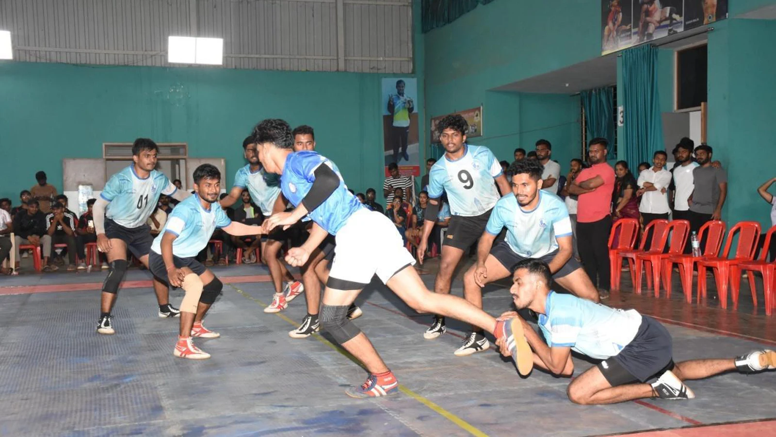 Men kabaddi players in action on court during RGUHS Kabaddi Men Inter Zone Tournament 2025-26 hosted at BLDE Campus Jamkhandi with audience watching in background September 2025