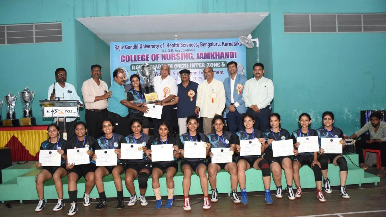 SDM College of Naturopathy and Yogic Sciences Ujire Women Kabaddi team winners receiving trophy and certificates at RGUHS Kabaddi Women Single Zone Tournament 2025-26 prize distribution function at BLDEA College of Nursing Jamkhandi