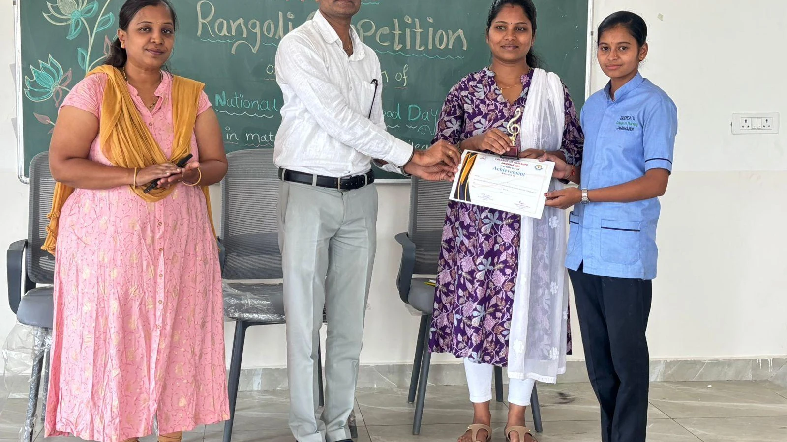 Prize distribution at National Safe Motherhood Day Rangoli Competition 2026 – BLDEA College of Nursing Jamkhandi