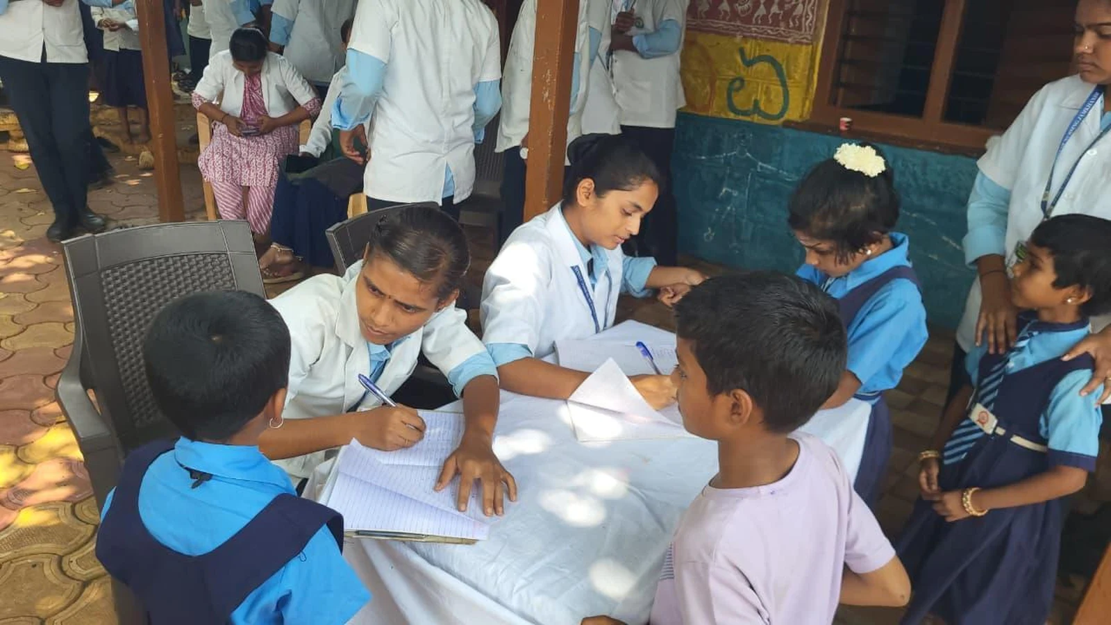 Fifth Semester BSc Nursing students BLDEA College of Nursing Jamkhandi conducting health records and assessment documentation at registration desk during School Health Programme Government Primary School Kakanwadi June 2026