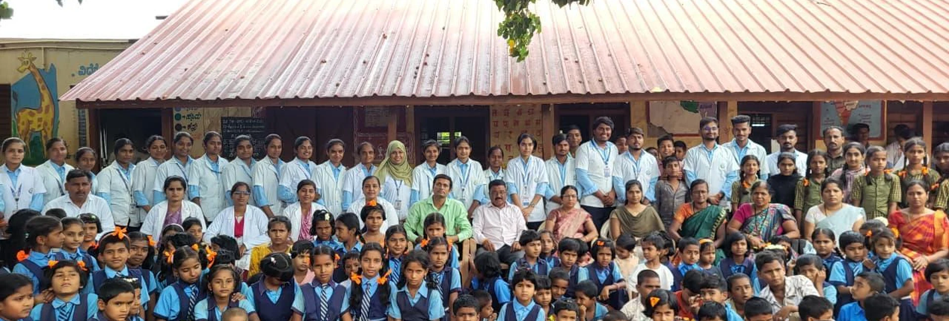 Fifth Semester BSc Nursing Students BLDEA College of Nursing Jamkhandi group photo with school children and faculty in front of Government Primary School Kakanwadi during School Health Programme June 2026