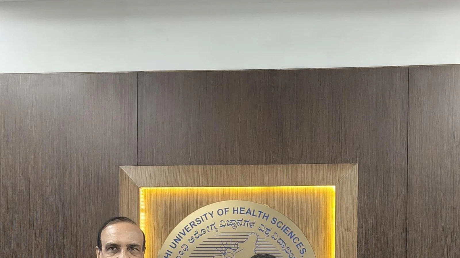 RGUHS Vice-Chancellor Bhagawan B. C. presenting University Blue Honour certificate to Ms. Deepa Vibhuti BSc Nursing student BLDEA College of Nursing Jamkhandi