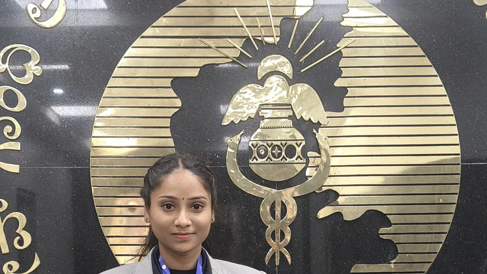 Ms. Deepa Vibhuti Third Semester BSc Nursing BLDEA College of Nursing Jamkhandi wearing University Blue Honour gold medal at RGUHS Bengaluru emblem
